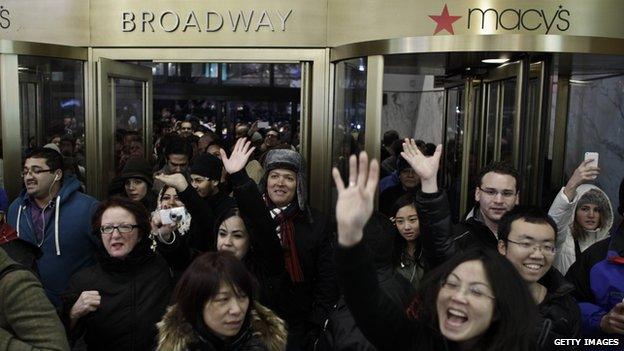 People enter Macy's Herald Square as the store opens its doors at 8 pm Thanksgiving day on November 28, 2013 in New York City