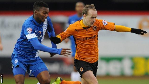 Peterborough United's Kgosi Nthle (left) and Wolverhampton Wanderers' Leigh Griffiths (right) battle for the ball.