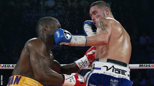 Tony Bellew (left) takes a punch from Adonis Stevenson