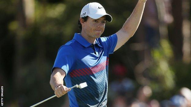 Rory McIlroy celebrates after holing the winning putt on the 18th