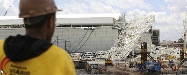 A worker looks on at the scene of the disaster at the Arena Corinthians