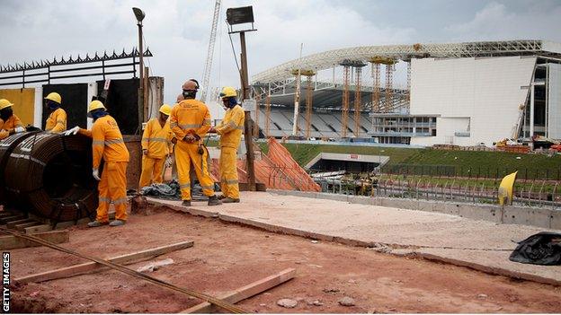 Workers constructing the Arena de Sao Paulo.