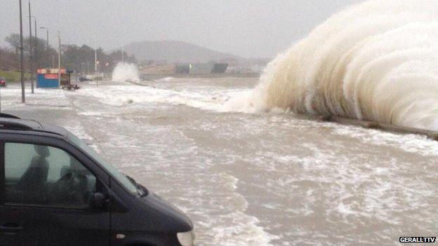 Waves crash over the sea wall at Porth Eirias, Colwyn Bay