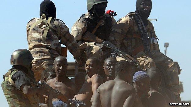 Malian soldiers transport in a pickup truck a dozen suspected Islamist rebels on February 8, 2013 after arresting them north of Gao.