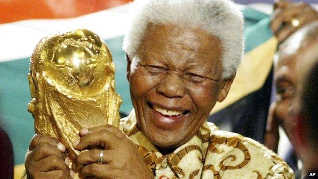 Former South African President Nelson Mandela lifts the World Cup trophy in Zurich, Switzerland, on 15 May 2004 after Fifa's executive committee announced that South Africa would host the 2010 World Cup