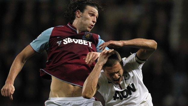 Andy Carroll jumps for the ball