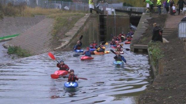 A group of kayakers move out of Dudbridge Upper Lock, Stroud