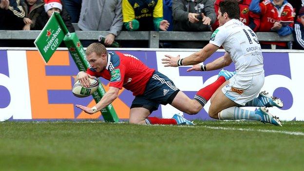 Keith Earls scores Munster's third try despite the efforts of James Hook