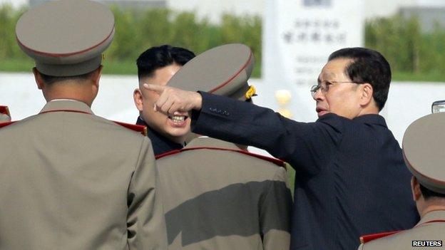 North Korean politician Chang Song-thaek (R) gestures next to North Korean leader Kim Jong-un (L) as they attend a commemoration event at the Cemetery of Fallen Fighters of the Korean People's Army (KPA) in Pyongyang, as part of celebrations ahead of the 60th anniversary marking the end of the 1950-53 Korean War, in this 25 July 2013 file photo