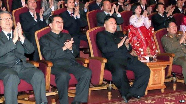 This file picture taken by North Korea's official Korean Central News Agency (KCNA) on 15 April 2013 shows North Korean leader Kim Jong-un (C-front) applauding at the Unhasu orchestra concert, as his uncle, Chang Song-thaek (front 2nd L), looks on