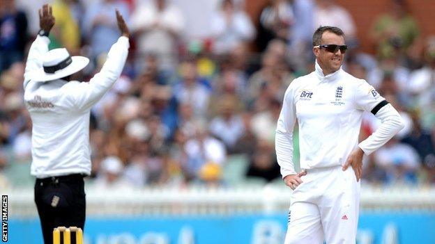 Graeme Swann looks on as his ball is hit for six