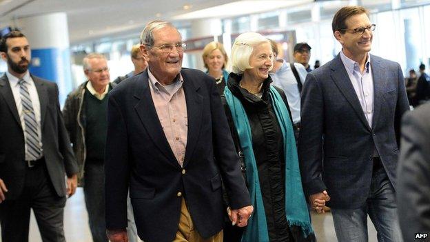 Korean War veteran Merrill Newman (C-L), 85, walks with his wife Lee (C-R) and son Jeff (R) after arriving at San Francisco International Airport on December 7, 2013 following his release from detention in North Korea