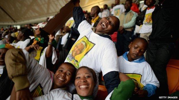 Members of the public attend the Nelson Mandela memorial service at the FNB Stadium, South Africa - 10 December 2013