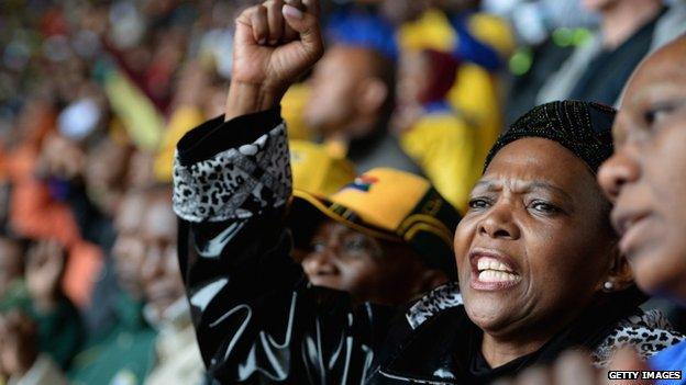 People gesture at the FNB stadium ahead of the national memorial service for Nelson Mandela