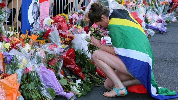 A woman mourns in Cape Town on 6 December 2013