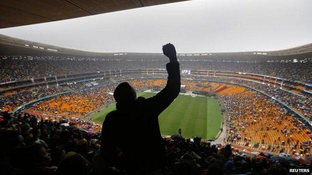 Man cheers Barack Obama's speech at Nelson Mandela's memorial, FNB stadium, Johannesburg (10 December)