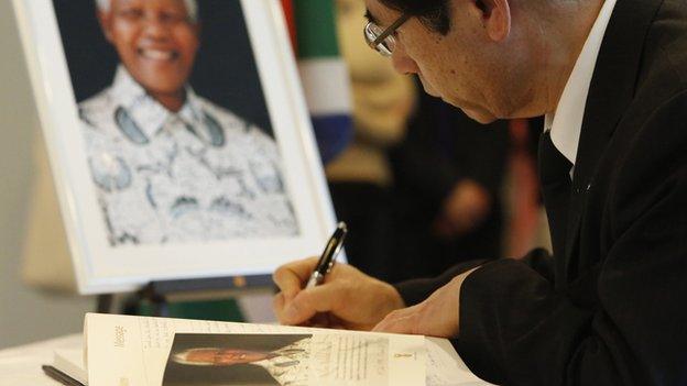 Man signs condolence book for Nelson Mandela