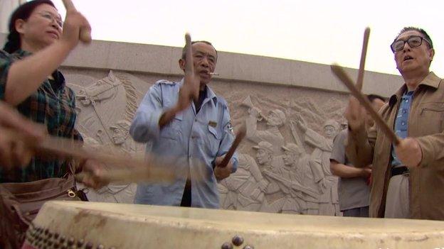 Drummers pounding out a beat for Dancing Grannies in China