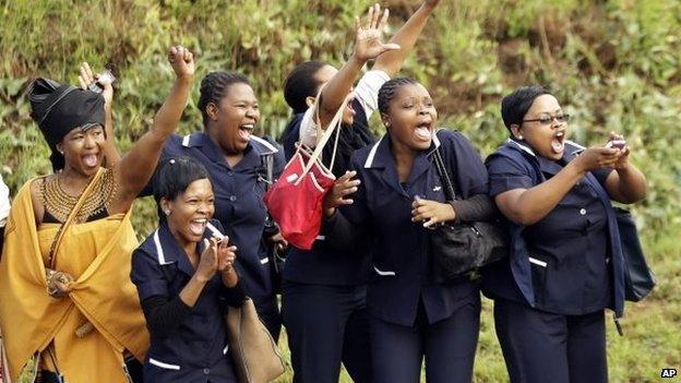 Hospital staff react as the procession for Nelson Mandela leaves the military hospital in Pretoria, December 11