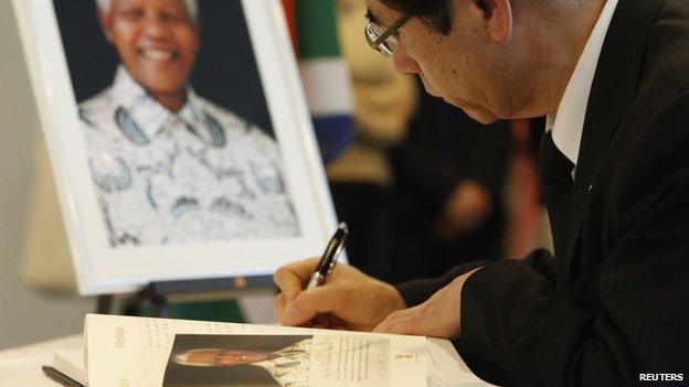 Man signs condolence book for Nelson Mandela