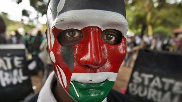 Demonstrator wears a mask in the colours of the Kenyan flag - June 2013