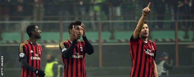 Milan players celebrate reaching the last 16