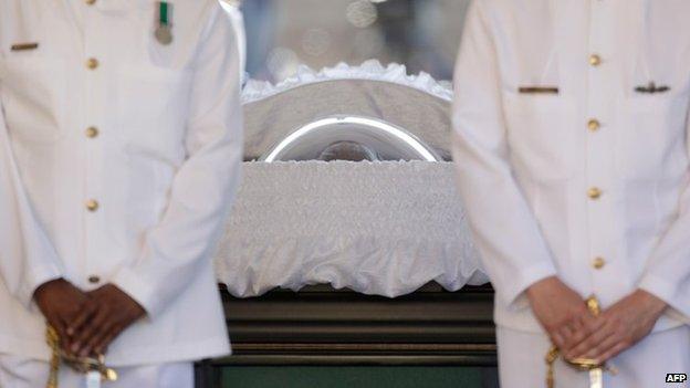 Navy officers guard the coffin of former South African President Nelson Mandela during the lying in state at the Union Buildings in Pretoria on December 12, 2013.