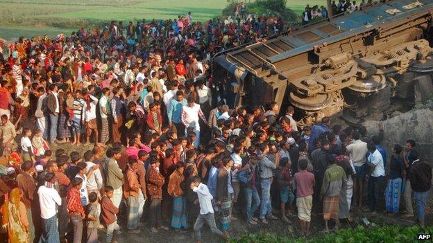 Bangladeshi onlookers gather at the scene of a derailed train in Gaibandha, some 200 kms north from Dhaka, on December 4, 2013