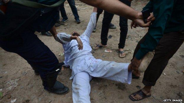 Bangladesh police detain a Jamaat-e-Islami activist during a protest in Dhaka on February 12, 2013