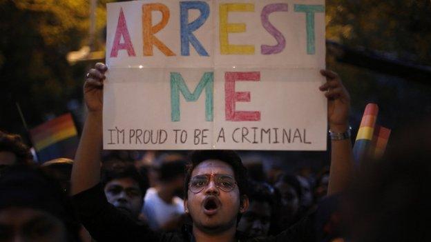 An Indian gay rights activist holds up a placard during a protest after the country's top court ruled that a colonial-era law criminalizing homosexuality will remain in effect in India in New Delhi, India, Wednesday, Dec. 11, 2013.