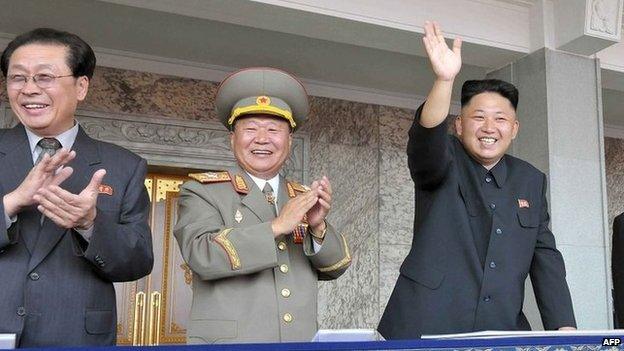 This file picture taken by North Korea's official Korean Central News Agency (KCNA) on 9 September 2013 shows North Korean leader Kim Jong-un (R), accompanied by his uncle Chang Song-Thaek (L), waving as he inspects a mass parade of the Worker-Peasant Red Guards at Kim Il-Sung Square in Pyongyang to mark the 65th anniversary of the national foundation day