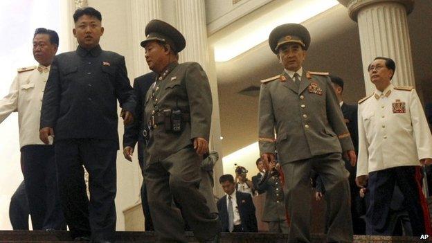 North Korean leader Kim Jong Un, second left, flanked by Yang Hyong Sop, second right, vice president of the Presidium of North Korea"s parliament, his uncle Jang Song Thaek, right, and Choe Ryong Hae, vice Marshal, left, as he tours the newly opened Fatherland Liberation War Museum, Saturday, July 27, 2013 as part of celebrations for the 60th anniversary of the Korean War armistice in Pyongyang, North Korea. (AP Photo/Wong Maye-E)