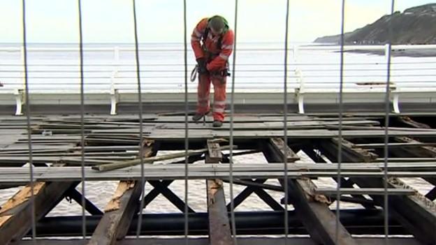 Contractor working on damaged Cromer Pier following