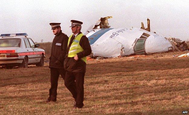 Picture dated 21 December 1988 showing two British policemen walking past wreck of the US-bound Pam Am Boeing 747