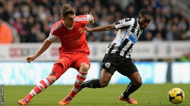 Vurnon Anita of Newcastle United tackles Jay Rodriguez of Southampton