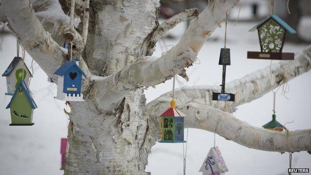 A tree is hung with birdhouses bearing the name of Sandy Hook Elementary School shooting victims as part of a memorial in Sandy Hook village in Newtown, Connecticut December 13, 2013.