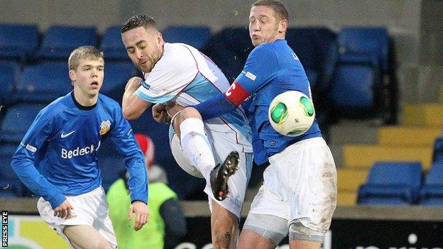 Ballymena striker Shane Dolan is challenged by Glenavon defender Kris Lindsay