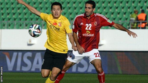 Guangzhou's Chinese midfielder Huang Bowen and Al Ahly Egyptian midfielder Mohamed Aboutrika