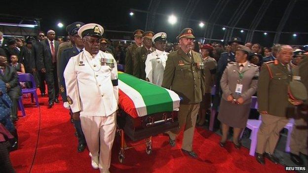 The coffin of Nelson Mandela is carried by military honour guard