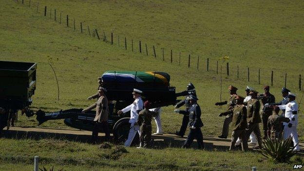 The coffin of Nelson Mandela on a gun carriage escorted by military honour guard