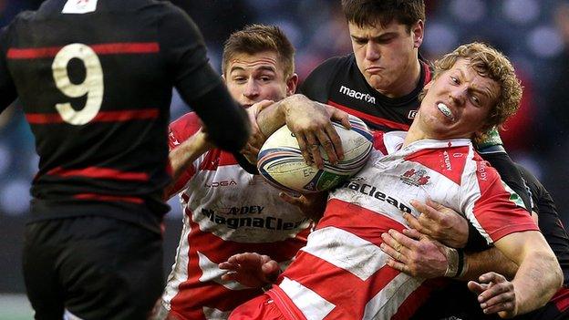 Henry Leonard of Edinburgh tackles Gloucester's Billy Tweveltrees