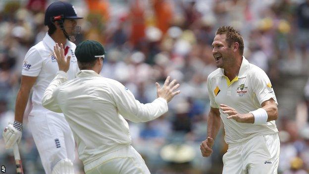 Ryan Harris (right) celebrates after bowling Alastair Cook (left)