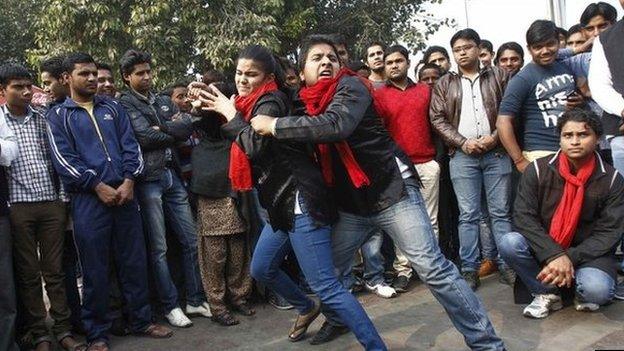 Demonstrators perform a street play on rape during a protest to mark the first anniversary of the Delhi gang rape, in Delhi December 16, 2013.