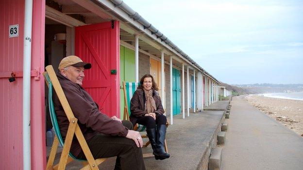 Roger and Sheila Widdup sat on deckchairs outside their beach hut