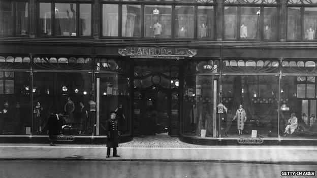 1925: A doorman stands at the entrance to Harrods,