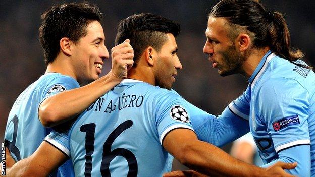 Man City players celebrate in the Champions League