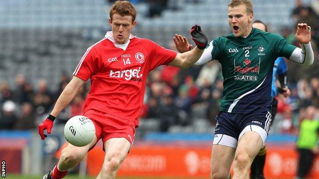 Peter Hughes is challenged by Kildare's Peter Kelly