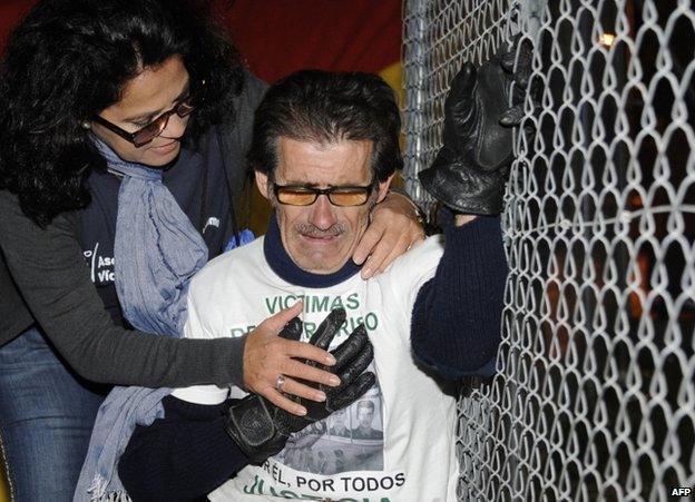 A woman comforts a member of a group of victims of terrorism as an Eta member is freed from a prison near Cadiz, 14 November