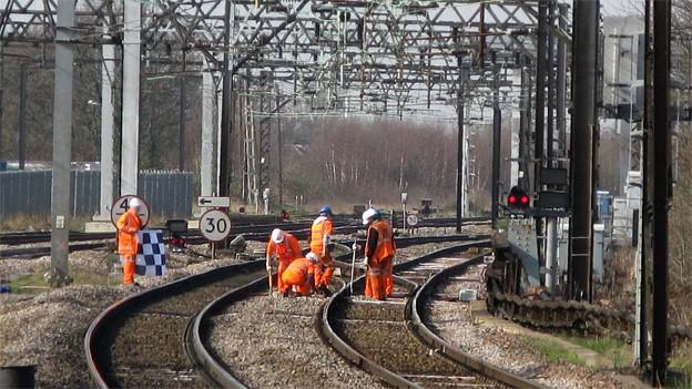 Railway workers on train tracks