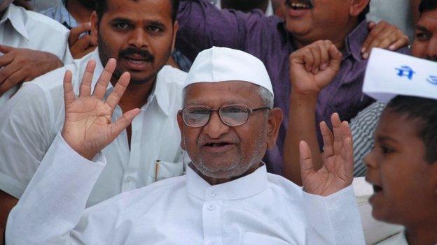 Indian social activist, Anna Hazare celebrates breaking his fast with a glass of fruit juice on the ninth day as Parliament passed the Lokpal Act, in Ralegan Siddhi in western Maharashtra state on December 18, 2013.